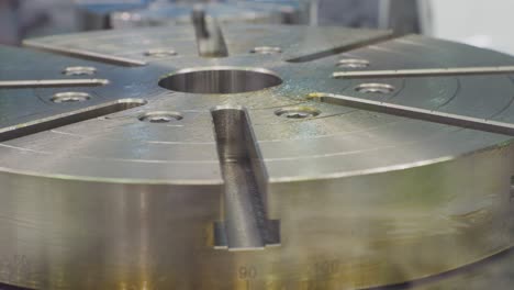 round metal part rotates on a metalworking machine.close-up