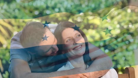 animación de la bandera de honduras sobre una feliz pareja caucásica abrazándose