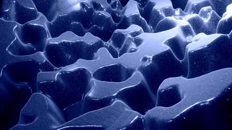stylish festive abstract black bg. fantastical looped background, waves move on glossy surface like landscape made of liquid blue wax with sparkles. beautiful soft background with smooth animation 4k