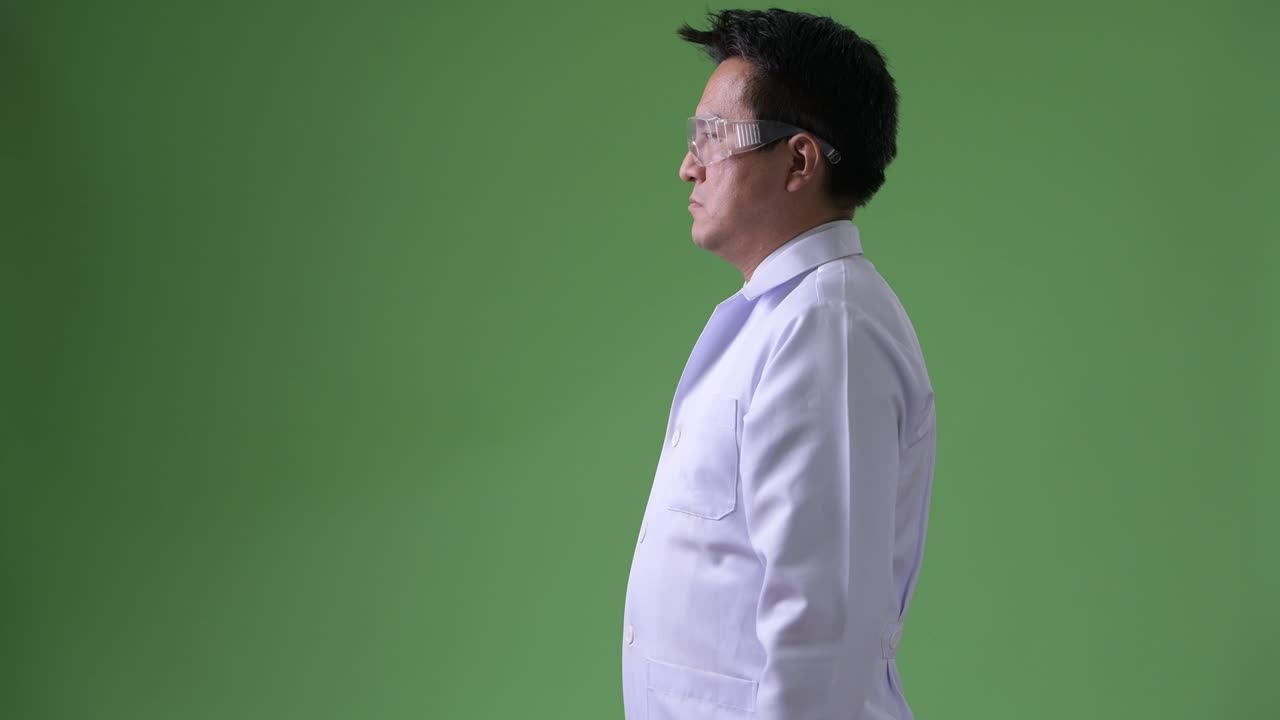 Mature Japanese man doctor wearing protective glasses