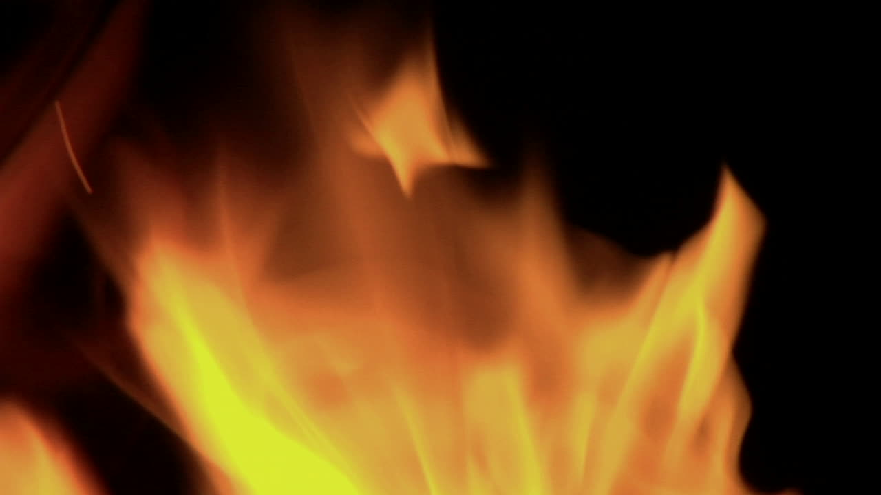 Flickering orange flames burn in a blazing fire 1