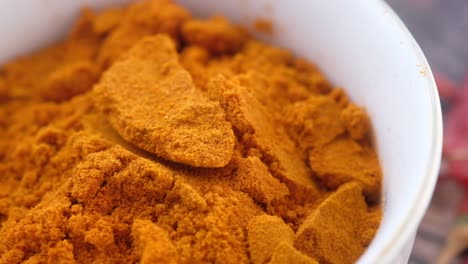 close up of turmeric powder in bowl