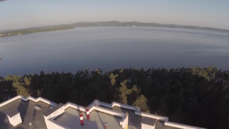 aerial view of multi-story buildings by a lake
