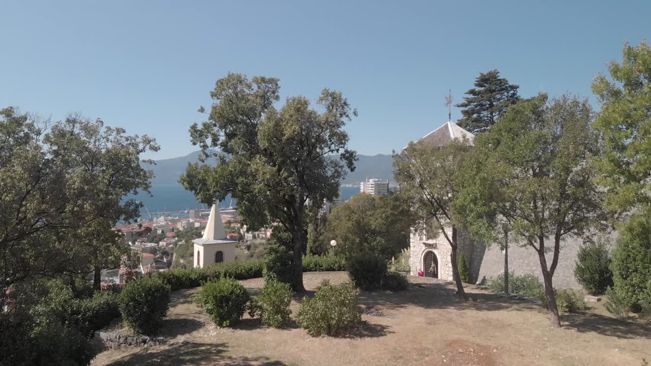 Rising up through the manicured gardens od Castle Trsat sitting on a steep hill above Rijeka Croatia, aerial
