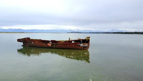 aerial drone view of old shipwreck in motueka, nelson, new zealand