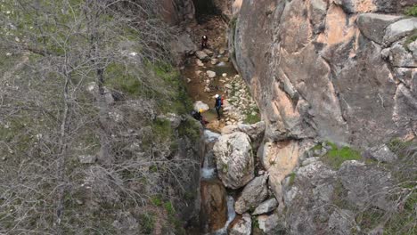 Canyoning-inside-a-ravine-right-next-to-a-precipice-and-waterfall