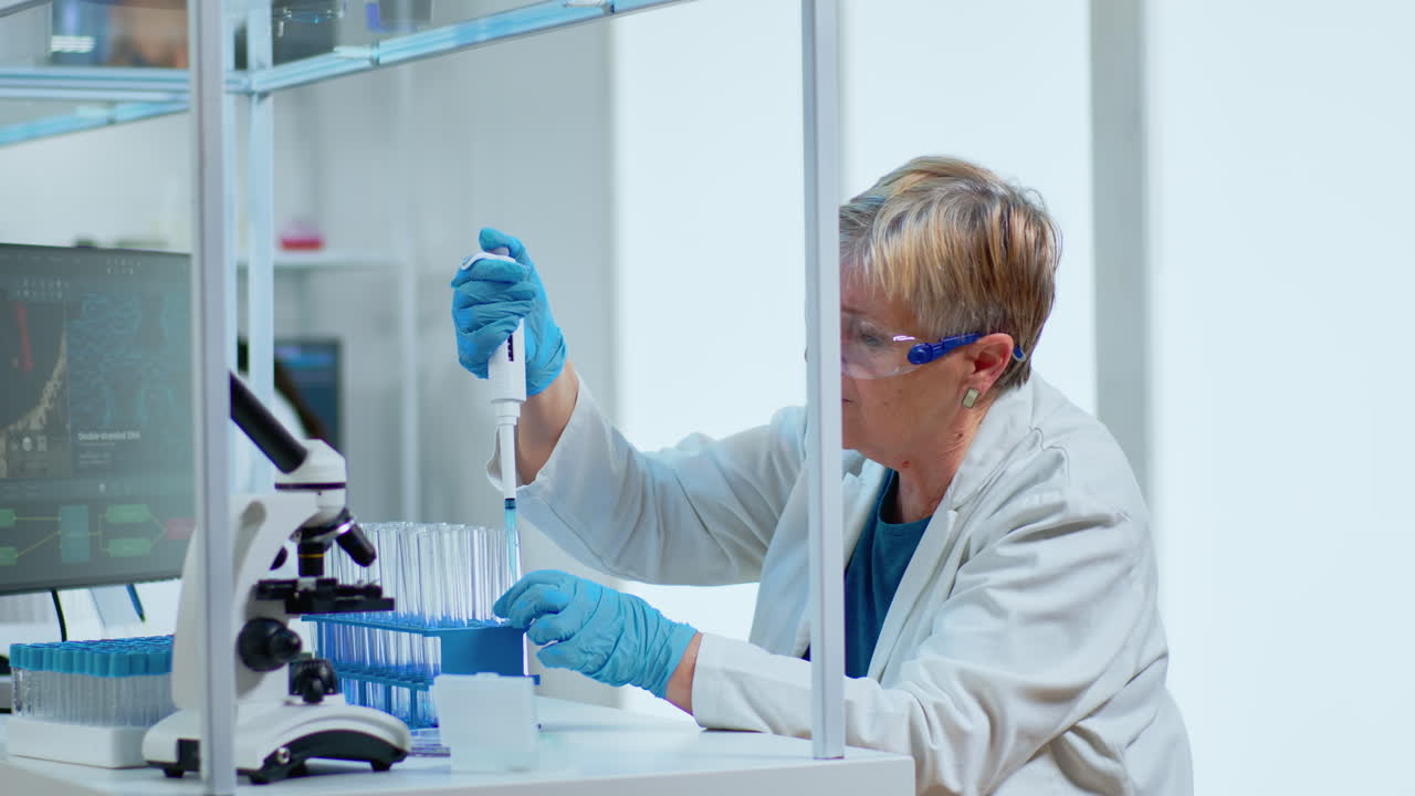 Senior scientist woman pipetting liquid to test tube