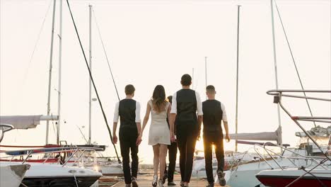 group walking on a dock at sunset