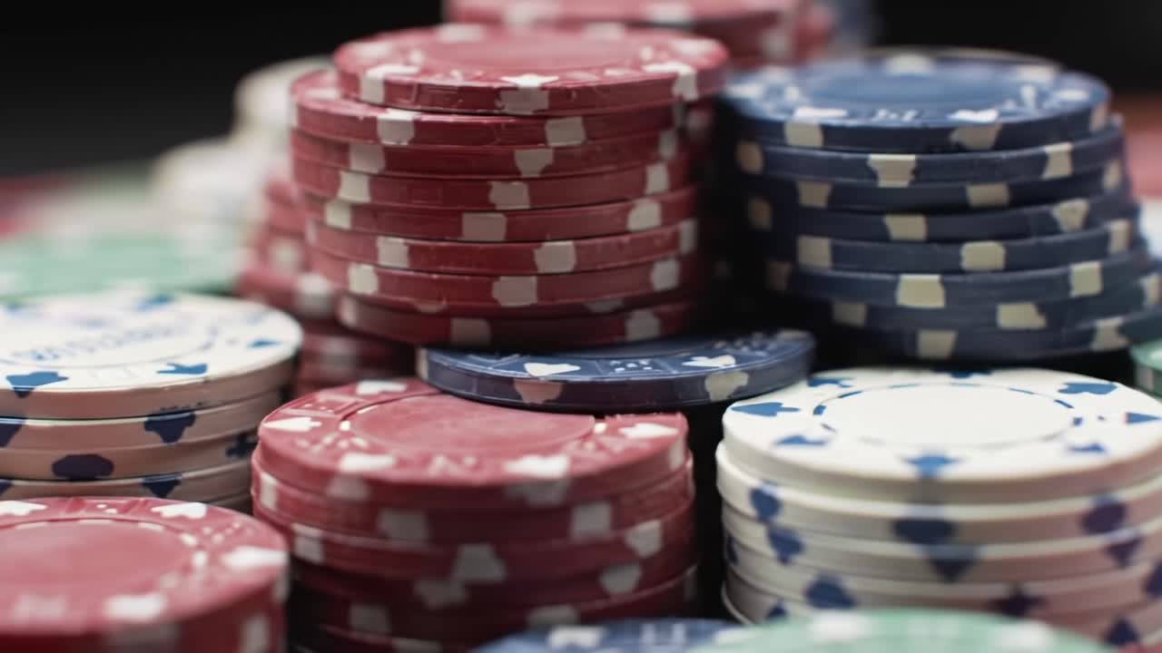 A Close-Up View of Colorful Poker Chips Stacked on a Felt Table, Highlighting Their Varied Patterns and Textures in a Gaming Environment
