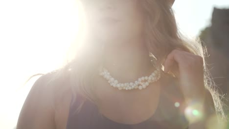 a lovely woman wearing a white beaded necklace - ontario canada - close up shot