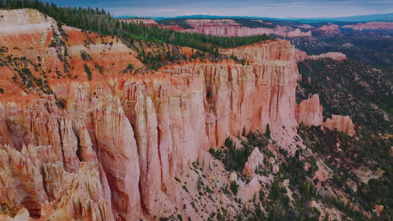 Fascinating coral rocks of Bruce Canyon National Park in Utah, USA. Pine trees growing on top of the mountains.