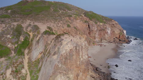 orbiting shot of couple on beach cliff - point dume