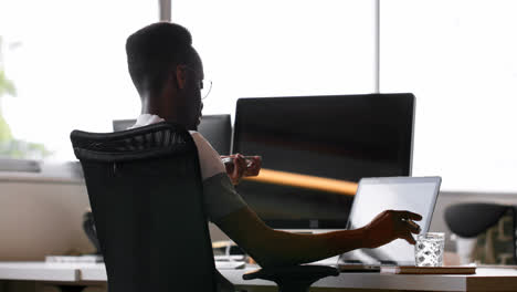 male executive talking on mobile phone at desk 4k