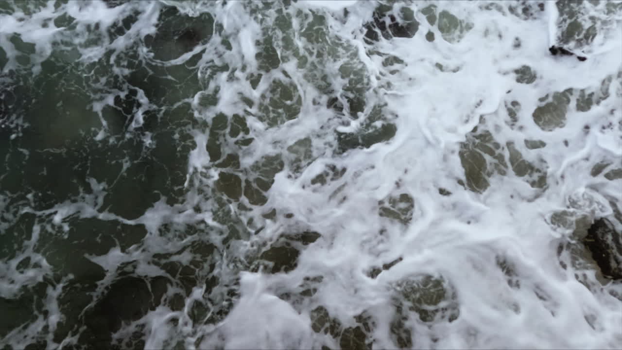 Close-up of dark water waves surface and texture