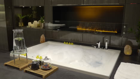 empty spa jacuzzi with bubbles and fireplace in the hotel