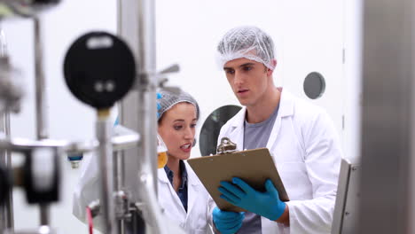 brewers checking the product in beaker