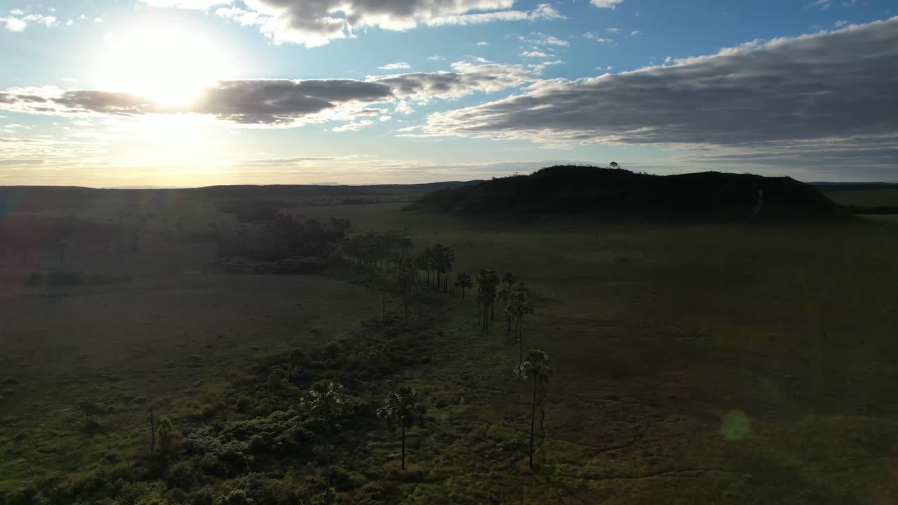 drone Maytrea Garden and Morro da Baleia, panoramic aerial Jardim de Maytrea, green fields, mountains, sunset, Chapada dos Veadeiros, Goiás, Alto Paraíso