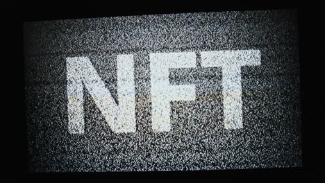 nft inscription on a monitor screen in white static white tv noise, no signal