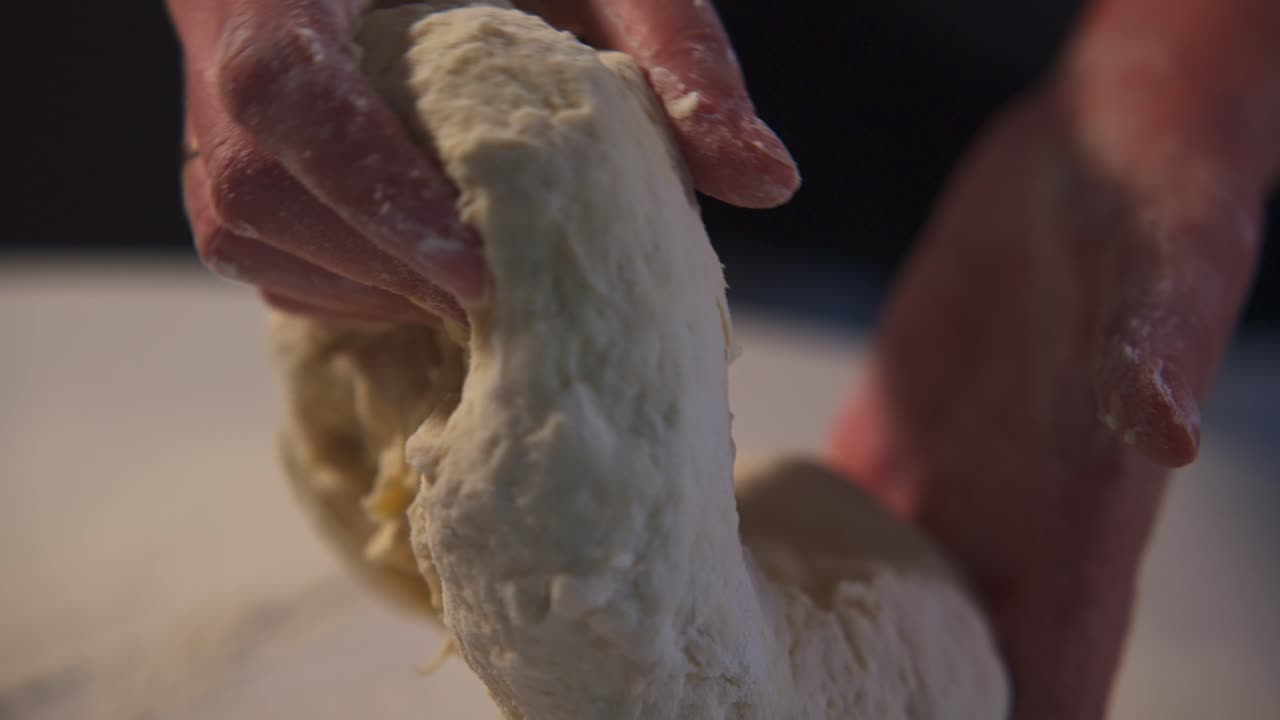 Close-up of Hands Kneading Fresh Dough for Baking