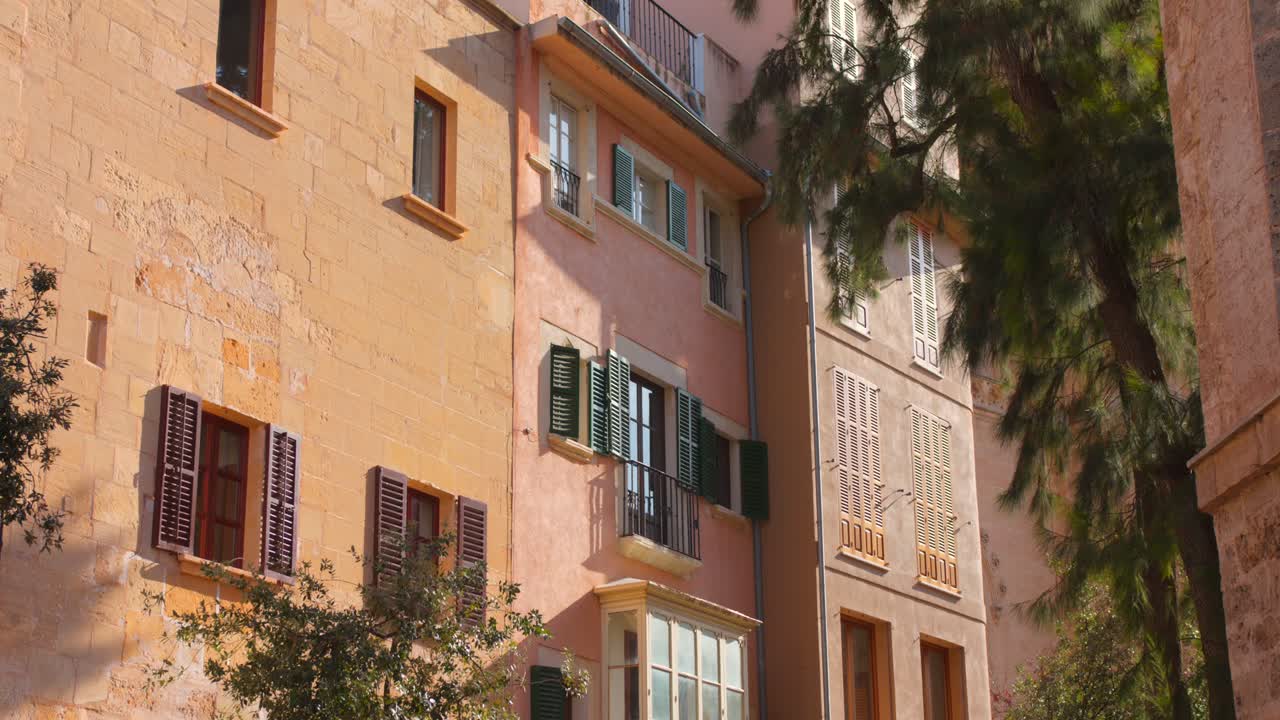 Charming view of pastel-colored buildings with shutters in Palma de Mallorca's old town