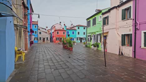 washing clothes line across empty street of colourful painted houses wide shot
