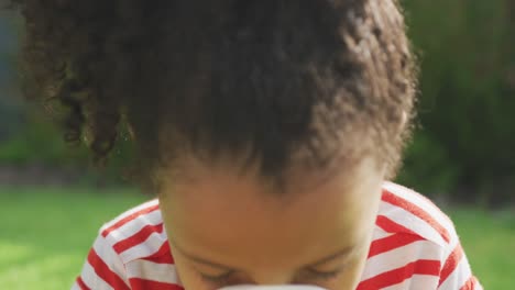 African-american-girl-sneezing-in-a-tissue-outside-