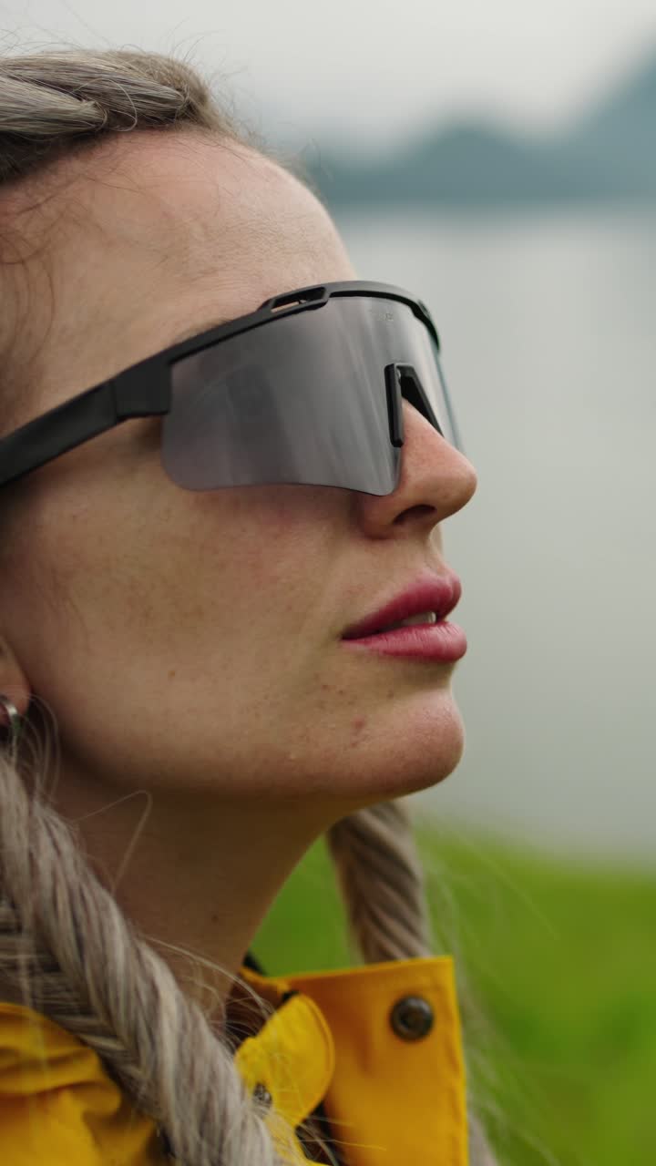 Close-up Profile of a Woman in Sunglasses Looking Up Outdoors