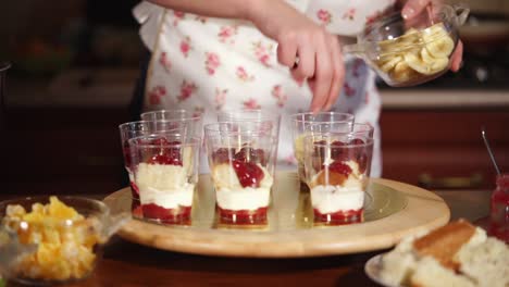 making layered desserts with banana and cherries