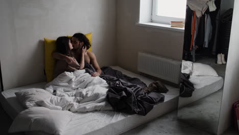 young man and woman in bed