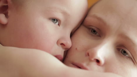 mother and baby kissing laughing and hugging