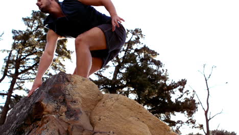 man reaching the top of his hike