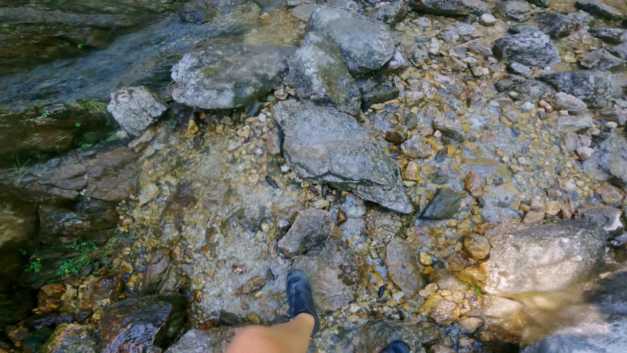 First-Person Point of View of Cyclist Walking to Stunning Waterfall on Sunny Day