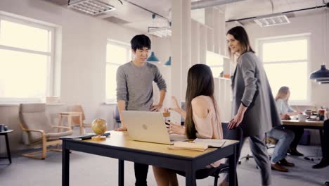 camera follows female leader enter office, then chat with colleagues. happy multiethnic business people discussion 4k