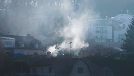 Heavy-smoke-rises-from-the-chimney-of-the-old-house