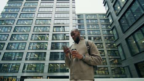 businessman using phone outside office building