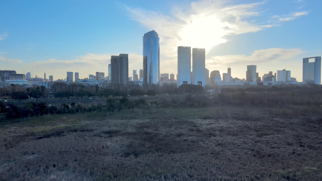 Nature vs City - nature reserve next to metropolis; Buenos Aires, Argentina - Backlit Sunset scene with lens flare