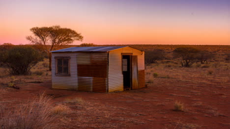 remote desert shack at sunset