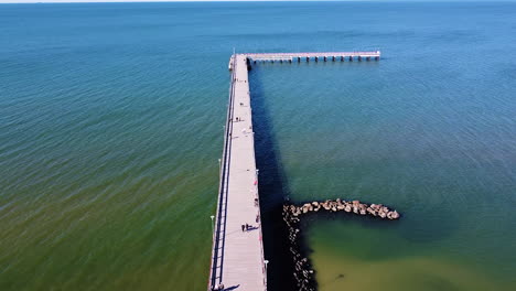 Almost-empty-bridge-of-Palanga-on-sunny-day,-aerial-ascend-view