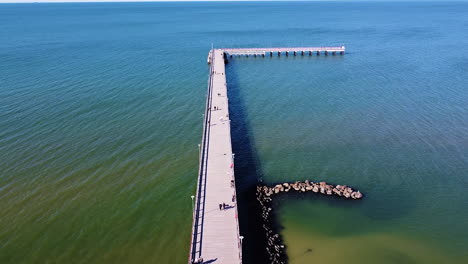 almost empty bridge of palanga on sunny day, aerial ascend view