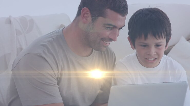 Animation of lights over happy caucasian father and son reading on sofa