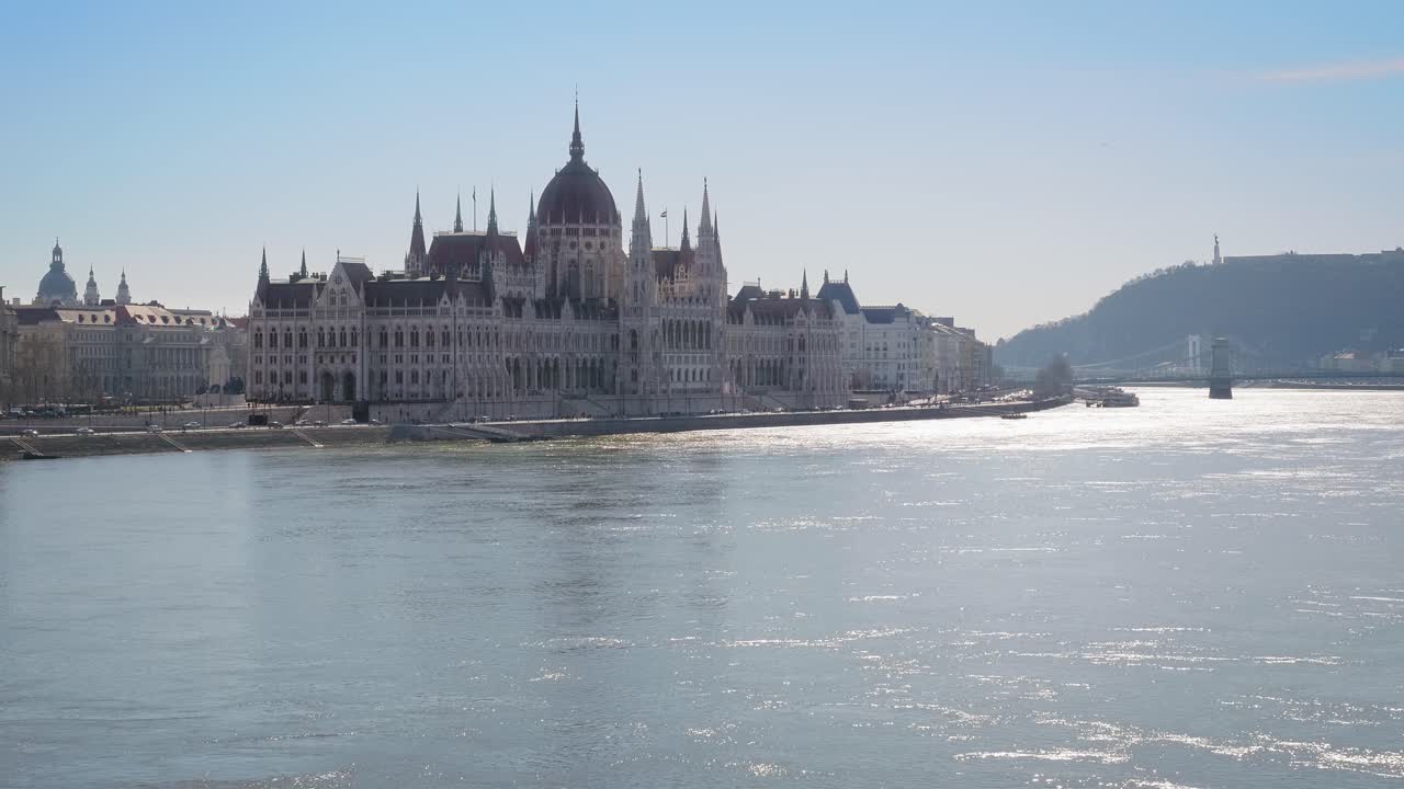 Center of Budapest with Hungarian Parliament and Szechenyi Chain Bridge over the Danube river. Sunny winter day, slow motion