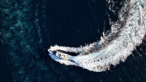 top down drone shot of luxury yacht driving at sea