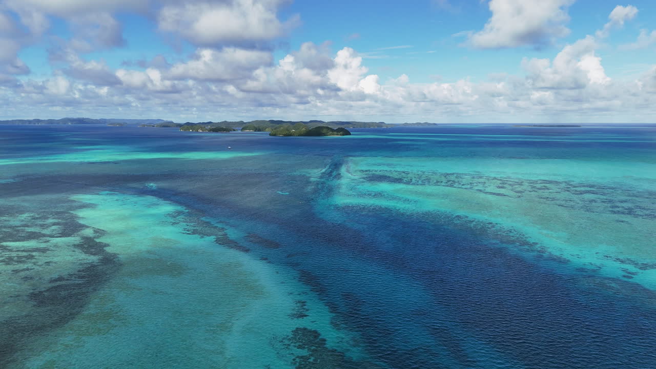 Scenic drone shot sweeping across the crystal blue waters and islands off the coast of Palau