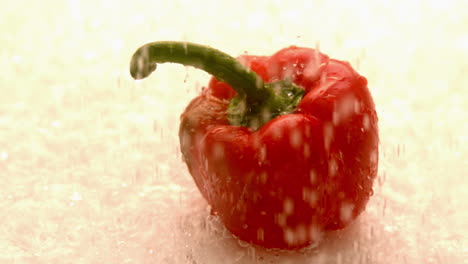 water raining down on red pepper