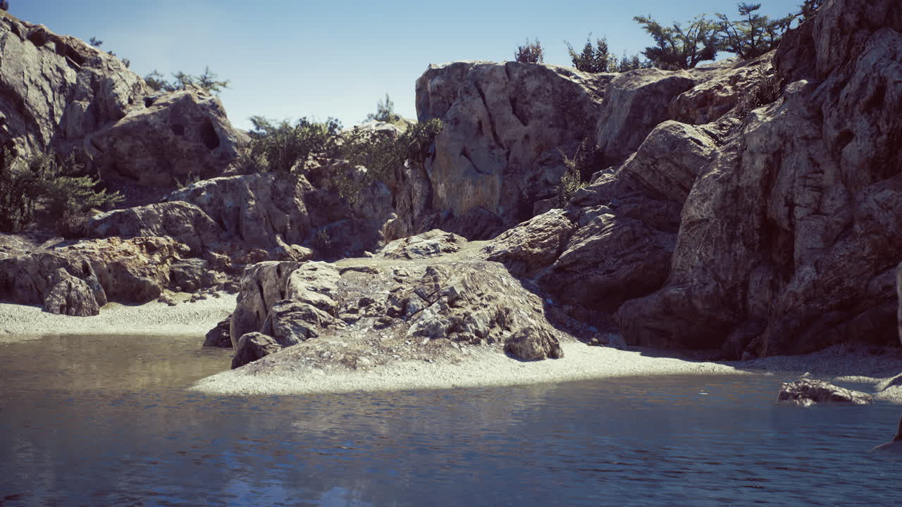 Rocky landscape surrounding calm water in a serene natural setting