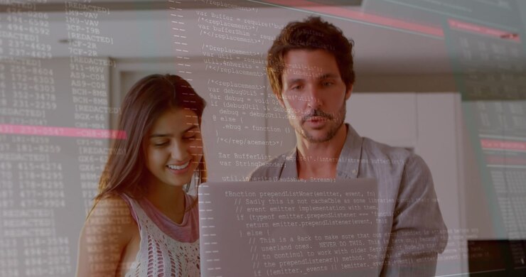 Man and woman holding laptop, tapping keyboard causing technology code overlay as man explaining