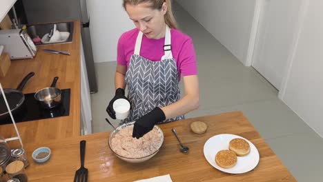 woman preparing homemade burgers