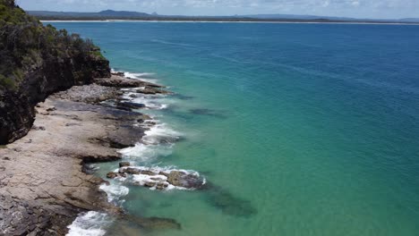 low flying over rocky beach