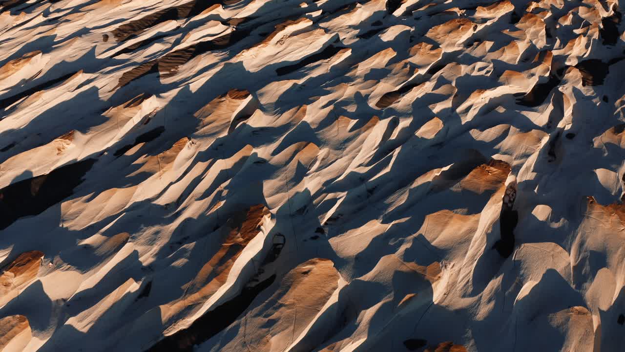Close of rippled pumice stone textures forming natural patterns across arid volcanic desert floor