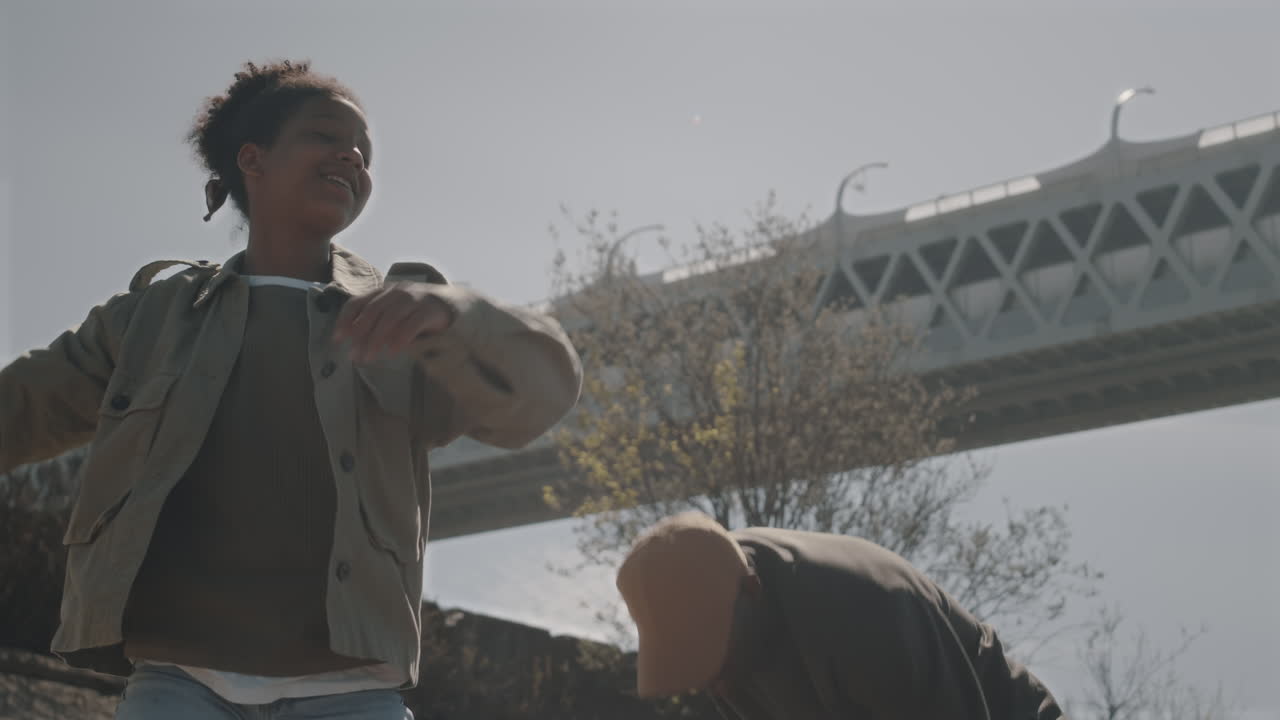 Young Black Couple Throwing Stones Outdoors